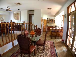 a dining room with a glass table and chairs at Melbourne Garden Bed and Breakfast in Melton