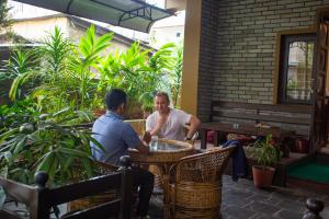 a man and a woman sitting at a table in a restaurant at Hotel Crystal Palace in Pokhara