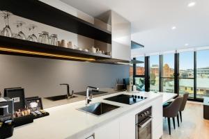 a kitchen with a large island and a counter top at FV by Peppers in Brisbane