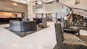 a lobby with a bar with chairs and stairs at Best Western Plus - Anaheim Orange County Hotel in Placentia