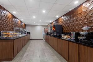 a restaurant with a long corridor with a food counter at Nobile Hotel Parkway at Celebration Orlando Very Close to Disney Theme Parks in Orlando +32 photos
