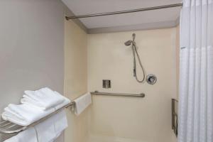 a bathroom with a shower and a toilet with towels at Days Inn by Wyndham Ukiah in Ukiah +22 photos