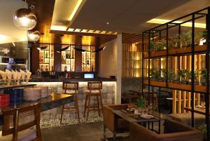 賈朗達爾的住宿－Ramada by Wyndham Jalandhar City Center，一间带桌椅的餐厅和一间酒吧