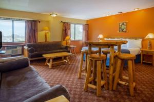 a hotel room with a bed and a table at Days Inn & Suites by Wyndham Stevens Point in Stevens Point