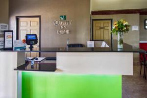 a lobby with a reception desk with a vase of flowers at Quality Inn Moore - Oklahoma City in Moore