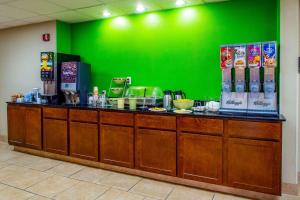 a green wall behind a counter in a restaurant at Quality Inn Moore - Oklahoma City in Moore