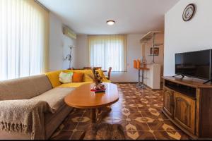 a living room with a couch and a table at Duplex apartments in Sveti Vlas