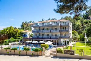 a hotel with a swimming pool and a resort at Green Bay in Limenaria