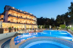 a large swimming pool in front of a hotel at Green Bay in Limenaria