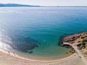 an aerial view of a beach and the ocean at Green Bay in Limenaria