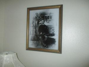 a picture of a man hanging on a wall at Virginia City Inn in Virginia City