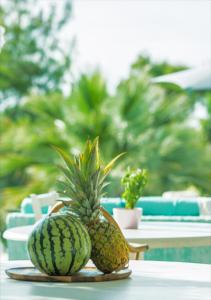 two pineapples sitting on a table in front of a table at Sanidiamonds in Sani Beach