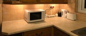 a microwave sitting on top of a kitchen counter at Relaxing double bedroom in Romford
