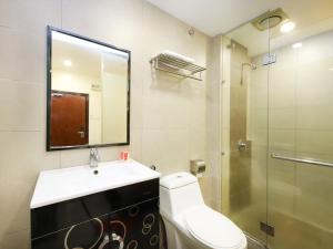 a bathroom with a toilet and a sink and a shower at Sunrise Golden Hotel in Kajang