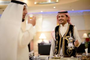 a man is taking a picture of another man at Boudl Khurais in Riyadh