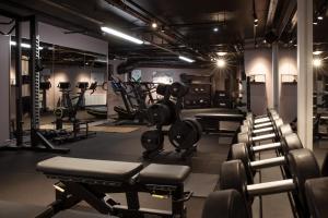a gym with a lot of equipment in a room at Clarion Hotel The Hub in Oslo