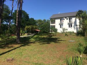 a house with a large yard in front of it at Private Cottage at the Black sea in Shekvetili