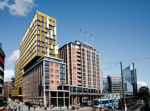 a city street with tall buildings and tall buildings at Clarion Hotel The Hub in Oslo