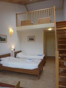 a bedroom with two beds and a bunk bed at Boerderij "De Verwondering" in Goudriaan