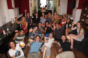a group of people posing for a picture with their glasses of wine at Hostel Lybeer Private Rooms just for two! in Bruges