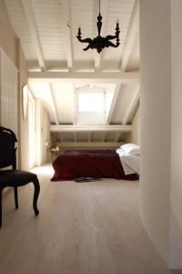 a bedroom with a bed and a ceiling with a chandelier at Via Paradiso 32 in Feltre