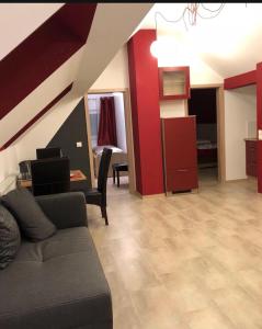 a living room with a couch and a red wall at SeMiHoMe in Dietingen