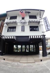 a building with an american flag in front of it at Apex Boutique Hotel @ Bandar Sunway in Petaling Jaya