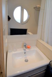 a bathroom with a sink and a mirror at logis la marine in Sidi Ifni