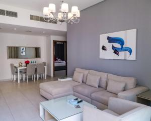 a living room with a couch and a table at The Spot Residence in Juffair