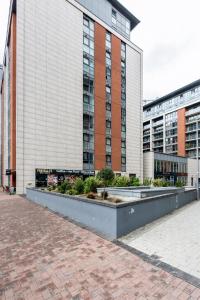 a large building with some plants in front of it at EXCEL LONDON MAJESTIC APARTMENT in London