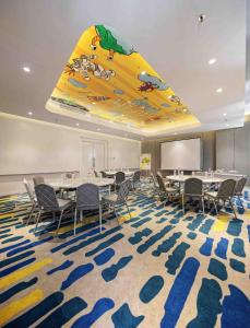 a conference room with tables and chairs and a slide at YELLO Hotel Harmoni in Jakarta
