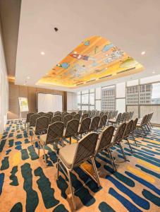 a conference room with chairs and a large ceiling at YELLO Hotel Harmoni in Jakarta