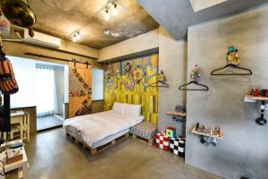 Postel nebo postele na pokoji v ubytování Anping Wikid Design Hotel