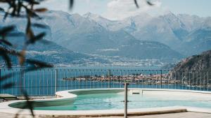 a swimming pool with a view of the mountains at Residence Primavera in Bellano