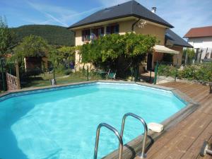 a swimming pool in front of a house at Villa Cathy T2 in Aix-les-Bains