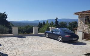 a blue car parked on top of a driveway at Villa Lavendel in Montauroux