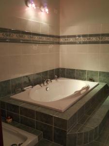 a bath tub in a bathroom with a sink at Villa Lavendel in Montauroux +13 photos