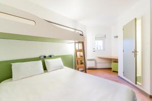 A bed or beds in a room at ibis budget Caen Hérouville