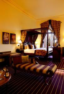 um quarto de hotel com uma cama e um sofá em Peckforton Castle em Tarporley