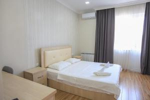 a bedroom with a bed and a large window at Hotel Botanica in Chakvi