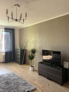 a living room with a flat screen tv on a wall at Apartman Skupovka in Most