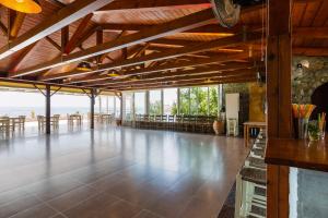 a large room with a dance floor with tables and chairs at Voukelari Rooms in Plakias