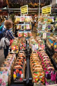 a woman standing in a market with a display of food at City Break Amsterdam BNB in Amsterdam
