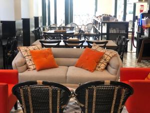 a couch with orange pillows on it in a store at Be Lisbon Hostel Intendente in Lisbon