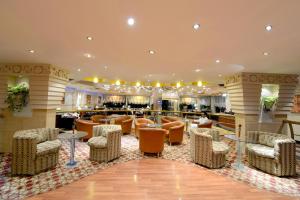 a lobby of a hotel with chairs and tables at Boudl Khurais in Riyadh