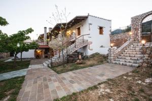 a house with a staircase in front of it at ARADENA TRADITIONAL House 3 in Arádhaina