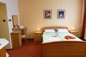 Postel nebo postele na pokoji v ubytování Hotel KAMU GARNI