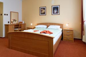 Postel nebo postele na pokoji v ubytování Hotel KAMU GARNI