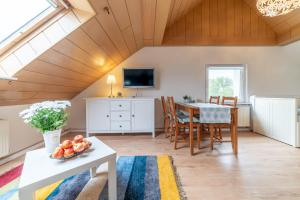 a living room with a table and a television at Privatzimmer mit eigenem Bad in Pattensen