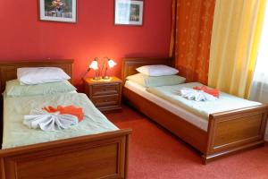 Postel nebo postele na pokoji v ubytování Hotel KAMU GARNI